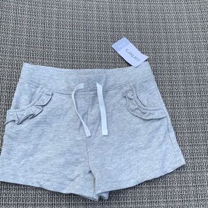 Carter’s gray shorts with ruffle pocket. Size 6/6x. NWT